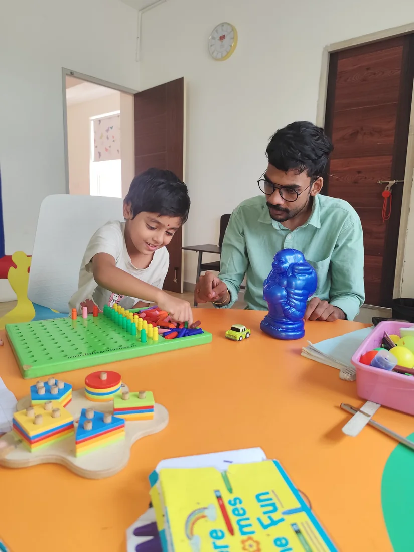 A therapist guiding a child with care